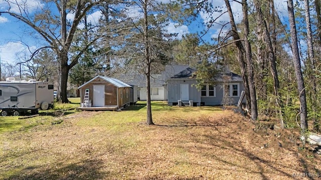 212 N Taylor St, Autaugaville, AL 36067 - view of yard featuring an outdoor structure and a storage unit