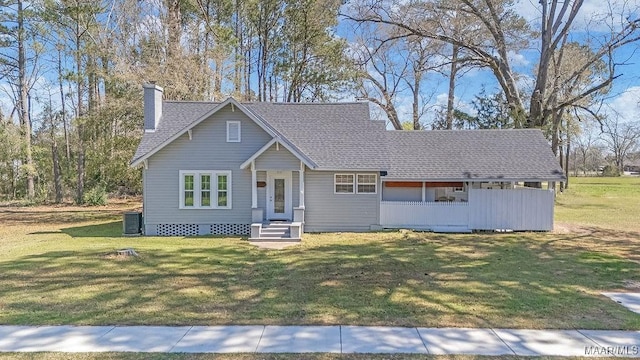 212 N Taylor St, Autaugaville, AL 36067 - view of front of home featuring a front yard, central air condition unit, roof with shingles, and a chimney