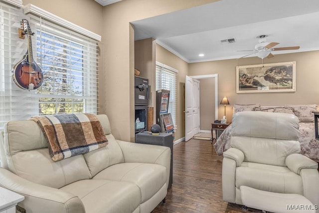 212 N Taylor St, Autaugaville, AL 36067 - living area with wood finished floors, a ceiling fan, visible vents, baseboards, and crown molding