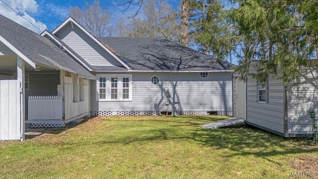 212 N Taylor St, Autaugaville, AL 36067 - back of property featuring an outbuilding, a storage unit, a lawn, and a shingled roof