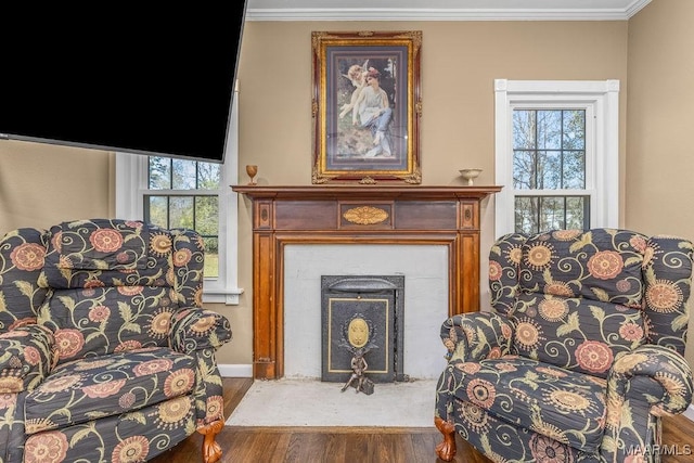212 N Taylor St, Autaugaville, AL 36067 - sitting room with a fireplace with flush hearth, wood finished floors, a wealth of natural light, and ornamental molding