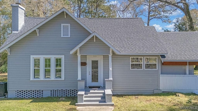 212 N Taylor St, Autaugaville, AL 36067 - view of front facade with a chimney, central AC unit, a shingled roof, and a front yard