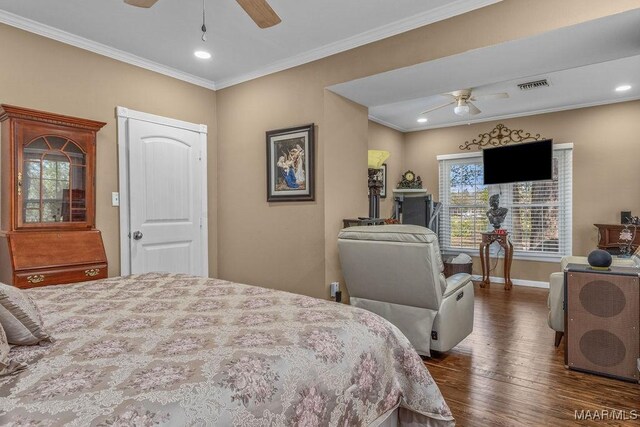 212 N Taylor St, Autaugaville, AL 36067 - bedroom with visible vents, dark wood-type flooring, ornamental molding, a ceiling fan, and baseboards