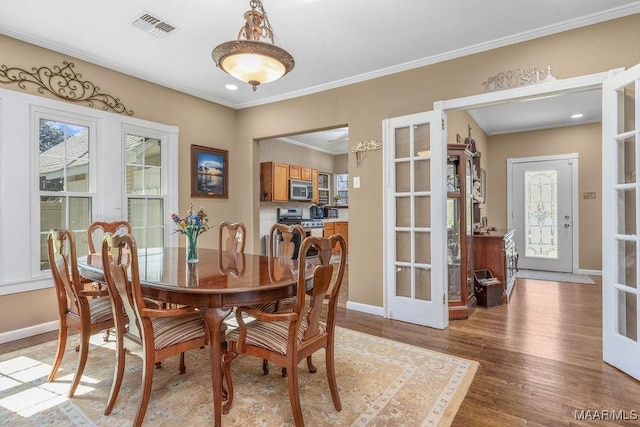 212 N Taylor St, Autaugaville, AL 36067 - dining space with light wood-type flooring, visible vents, baseboards, and crown molding