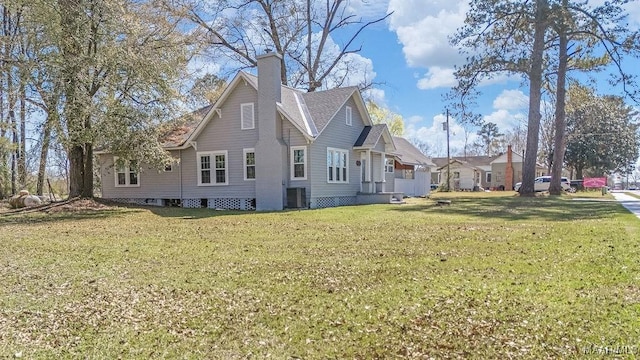 212 N Taylor St, Autaugaville, AL 36067 - view of side of home with central AC unit, a chimney, and a yard