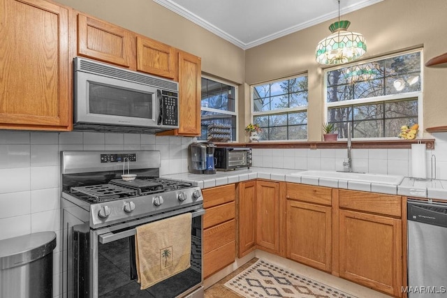 212 N Taylor St, Autaugaville, AL 36067 - kitchen featuring ornamental molding, a sink, appliances with stainless steel finishes, light tile patterned floors, and decorative backsplash