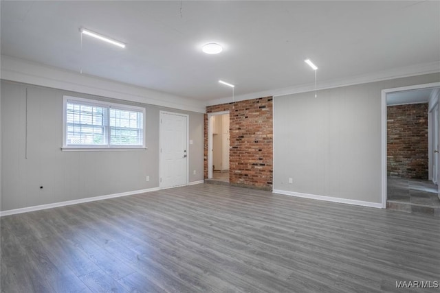 3740 Fieldcrest Dr, Montgomery, AL 36111 - empty room with wood finished floors, baseboards, crown molding, and brick wall