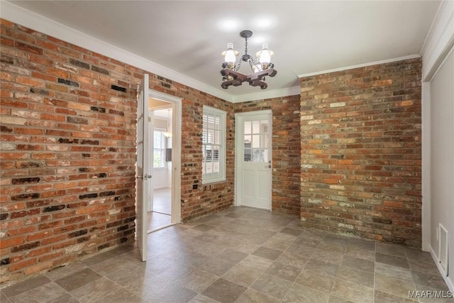 3740 Fieldcrest Dr, Montgomery, AL 36111 - empty room featuring brick wall, a chandelier, and crown molding