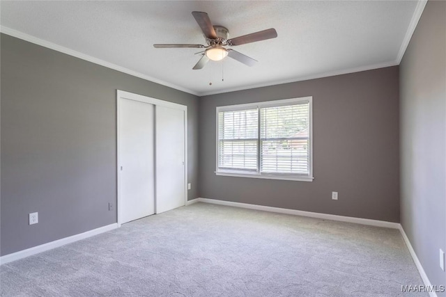 3740 Fieldcrest Dr, Montgomery, AL 36111 - unfurnished bedroom featuring carpet floors, ornamental molding, a closet, baseboards, and a ceiling fan