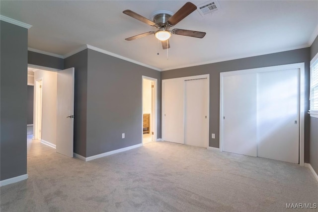 3740 Fieldcrest Dr, Montgomery, AL 36111 - unfurnished bedroom with two closets, crown molding, carpet floors, baseboards, and ceiling fan