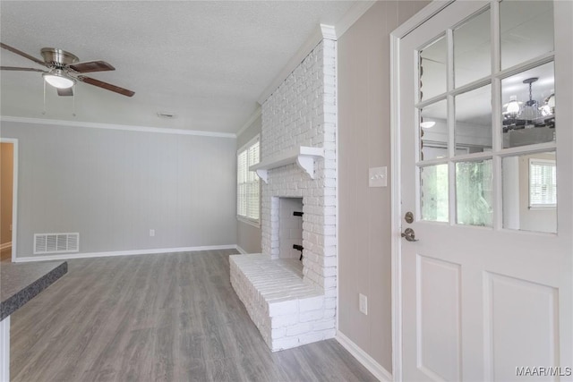 3740 Fieldcrest Dr, Montgomery, AL 36111 - unfurnished living room with wood finished floors, ceiling fan, ornamental molding, a brick fireplace, and baseboards