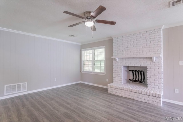 3740 Fieldcrest Dr, Montgomery, AL 36111 - unfurnished living room featuring wood finished floors, a brick fireplace, ceiling fan, a textured ceiling, and ornamental molding