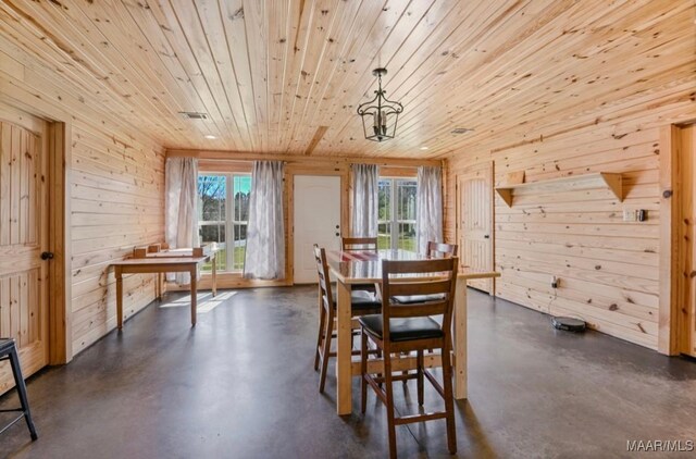 14291 Redland Rd, Tallassee, AL 36078 - dining space featuring plenty of natural light, wood walls, and finished concrete floors