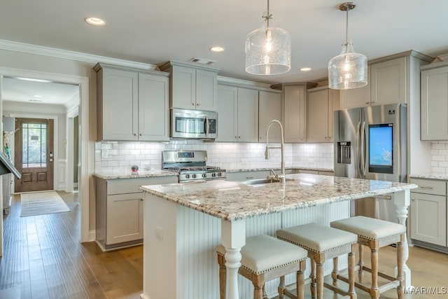 101 Ananias St, Troy, AL 36079 - kitchen with crown molding, stainless steel appliances, a sink, light wood finished floors, and visible vents