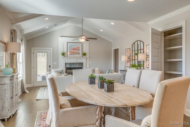 101 Ananias St, Troy, AL 36079 - dining space featuring light wood-style flooring, recessed lighting, a tiled fireplace, a ceiling fan, and vaulted ceiling