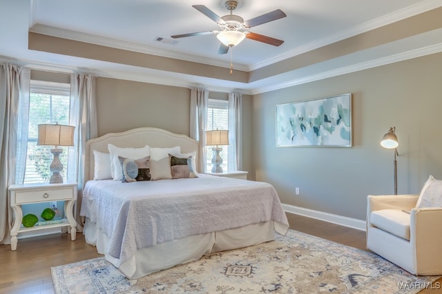 101 Ananias St, Troy, AL 36079 - bedroom with wood finished floors, a tray ceiling, crown molding, and visible vents