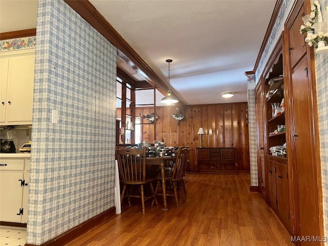 89 First Ave, Luverne, AL 36049 - dining space with wood finished floors, a textured ceiling, and ornamental molding