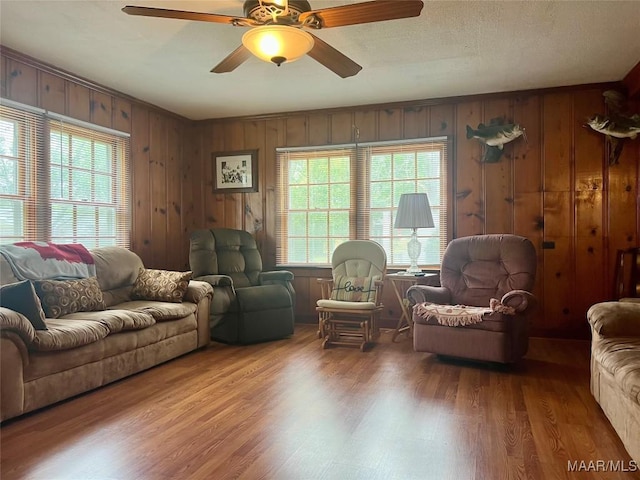 89 First Ave, Luverne, AL 36049 - living room with wood finished floors, ceiling fan, and wood walls