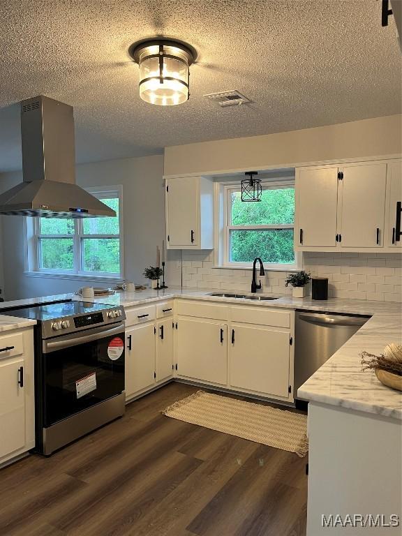 267 County Road 65th Rd, Valley Grande, AL 36701 - kitchen with island range hood, stainless steel appliances, white cabinets, a textured ceiling, and dark wood-style floors