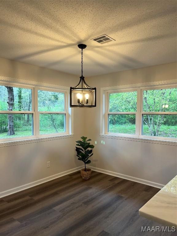 267 County Road 65th Rd, Valley Grande, AL 36701 - unfurnished dining area with a chandelier, dark wood-type flooring, and a textured ceiling