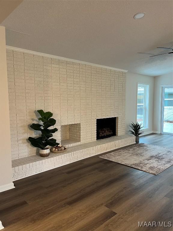 267 County Road 65th Rd, Valley Grande, AL 36701 - detailed view of a brick fireplace, wood finished floors, recessed lighting, and a textured ceiling