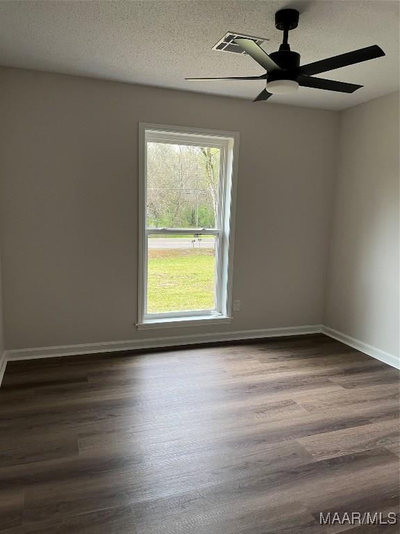 267 County Road 65th Rd, Valley Grande, AL 36701 - empty room featuring dark wood-style flooring, a ceiling fan, and a textured ceiling