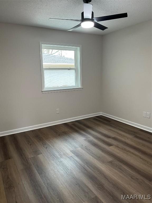 267 County Road 65th Rd, Valley Grande, AL 36701 - empty room with dark wood finished floors, a textured ceiling, and a ceiling fan