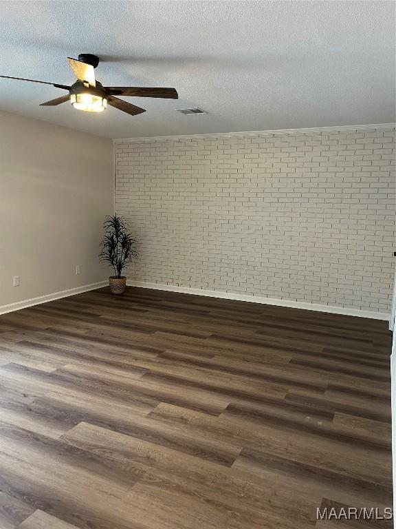 267 County Road 65th Rd, Valley Grande, AL 36701 - spare room with ceiling fan, brick wall, dark wood finished floors, and a textured ceiling