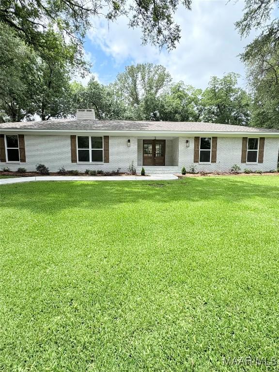 267 County Road 65th Rd, Valley Grande, AL 36701 - view of front of property with a front lawn, a chimney, and brick siding