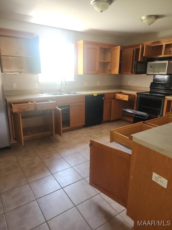 kitchen with black appliances, light countertops, and open shelves