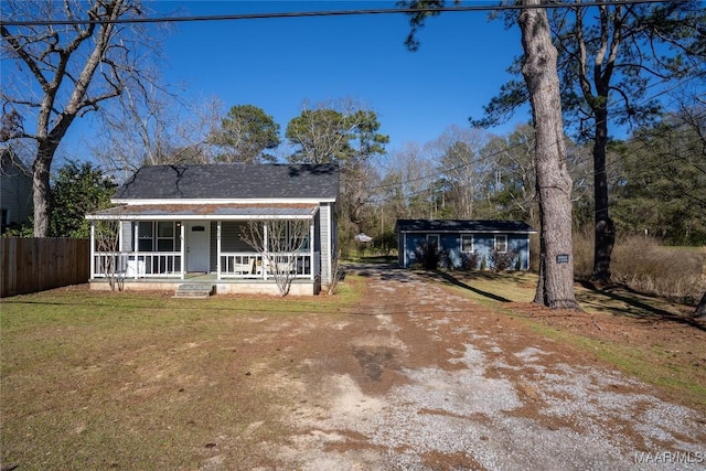 672 Lower Kingston Rd, Prattville, AL 36067 - rear view of property featuring an outdoor structure, fence, driveway, a porch, and a yard