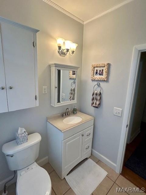 bathroom featuring tile patterned floors, toilet, baseboards, and vanity