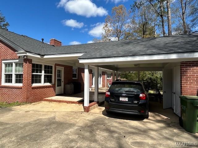 view of vehicle parking featuring an attached carport and driveway