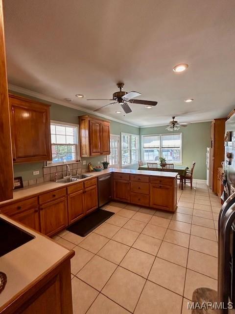 kitchen featuring a ceiling fan, light countertops, a sink, and light tile patterned flooring