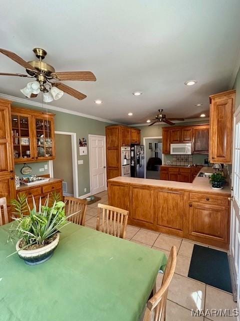dining room with ceiling fan, recessed lighting, light tile patterned floors, and ornamental molding