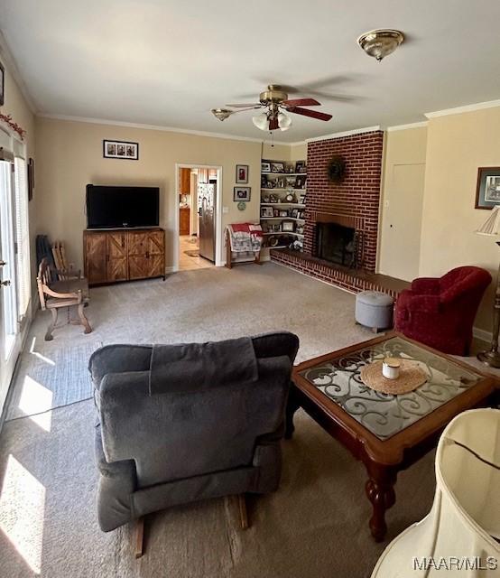 carpeted living room with a fireplace, ceiling fan, built in features, and crown molding