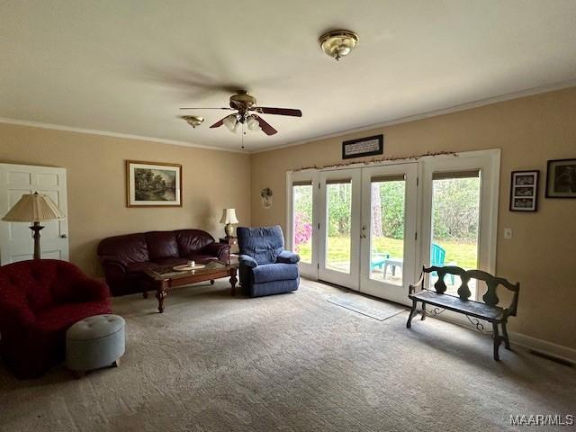 carpeted living room featuring french doors, ceiling fan, ornamental molding, and baseboards