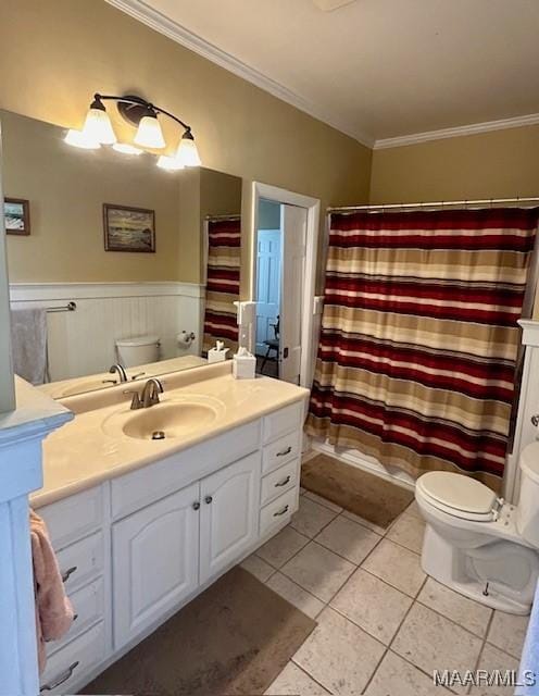 full bath with crown molding, toilet, tile patterned floors, vanity, and wainscoting