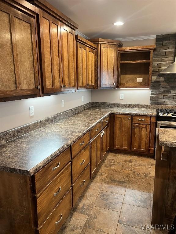 376 Mckenzie St, Mckenzie, AL 36456 - kitchen with open shelves, ornamental molding, gas range, dark countertops, and stone finish flooring