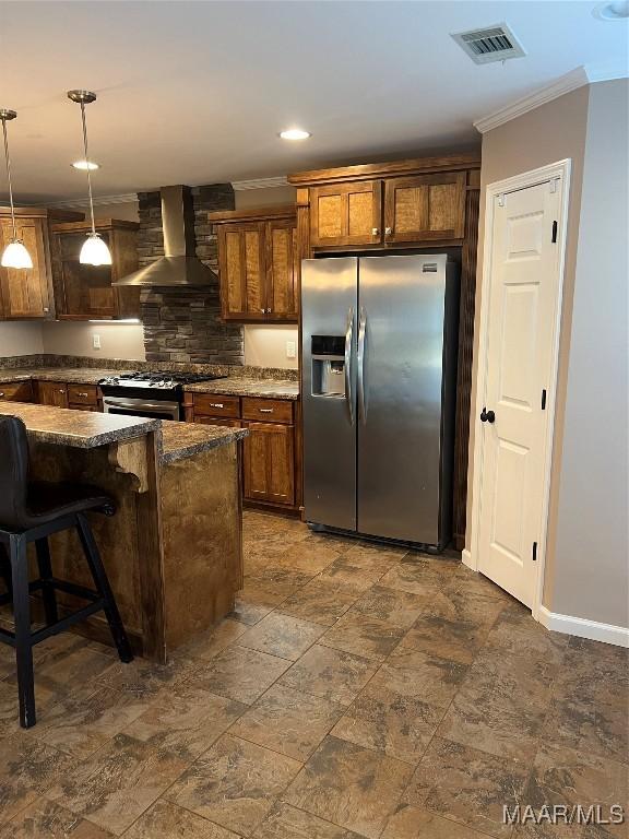 376 Mckenzie St, Mckenzie, AL 36456 - kitchen featuring ornamental molding, stainless steel appliances, pendant lighting, visible vents, and wall chimney exhaust hood