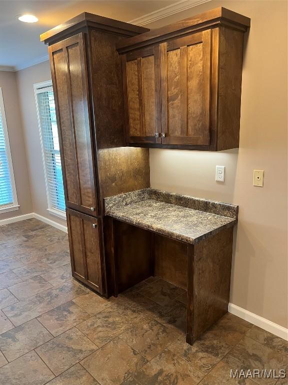 376 Mckenzie St, Mckenzie, AL 36456 - kitchen featuring baseboards, crown molding, and dark brown cabinets