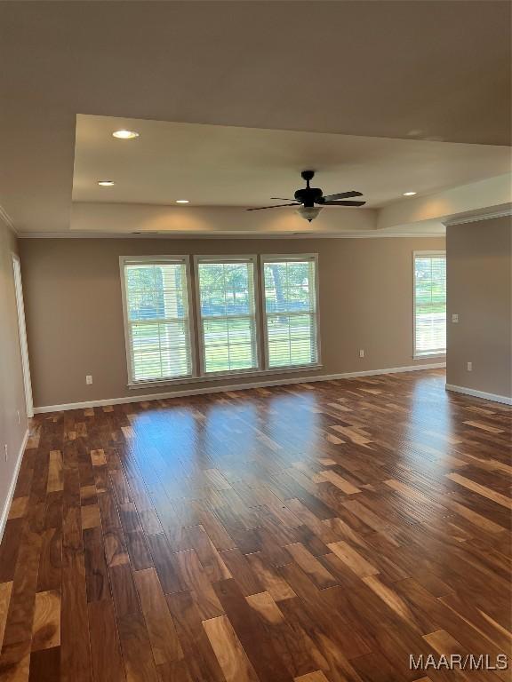 376 Mckenzie St, Mckenzie, AL 36456 - spare room with baseboards, ceiling fan, recessed lighting, dark wood finished floors, and a raised ceiling