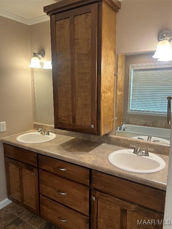 376 Mckenzie St, Mckenzie, AL 36456 - bathroom with double vanity, a sink, crown molding, and a garden tub