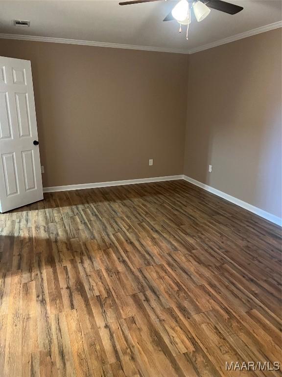 376 Mckenzie St, Mckenzie, AL 36456 - empty room with dark wood-style flooring, visible vents, ornamental molding, and ceiling fan