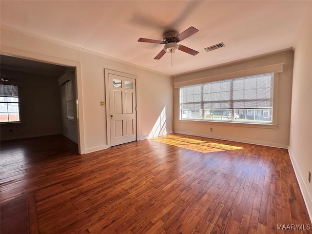 unfurnished living room featuring visible vents, a healthy amount of sunlight, a ceiling fan, and wood finished floors