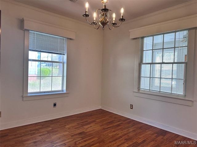 unfurnished room with dark wood-style floors, baseboards, ornamental molding, and a chandelier