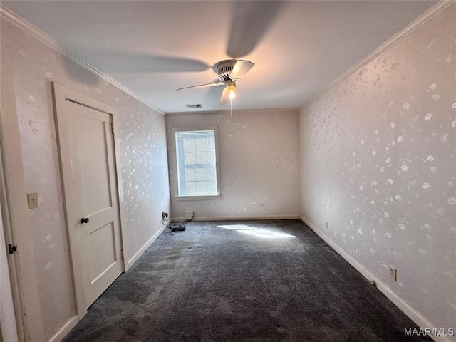 spare room with ornamental molding, carpet, wallpapered walls, visible vents, and ceiling fan