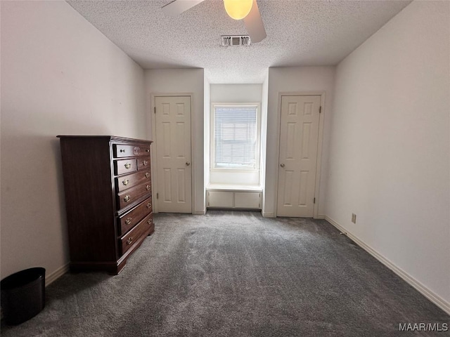 unfurnished bedroom featuring baseboards, visible vents, carpet, and a textured ceiling