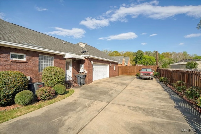 1580 W Overbrook Rd, Millbrook, AL 36054 - exterior space with a garage, cooling unit, fence, concrete driveway, and brick siding