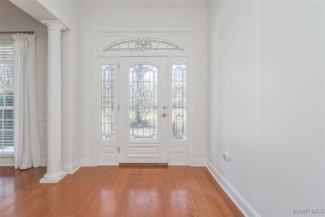 1580 W Overbrook Rd, Millbrook, AL 36054 - entryway featuring crown molding, baseboards, light wood-type flooring, and ornate columns